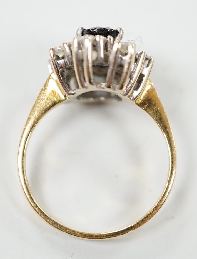 A modern 18ct gold, sapphire and diamond set oval cluster ring, size L, gross weight 4.8 grams.